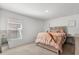 Relaxing bedroom features a comfortable bed, carpet, and a bright window at 541 Jerry Ln, Haines City, FL 33844