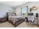 Cozy bedroom with a plush bed, modern decor, a dedicated desk, and a window at 541 Jerry Ln, Haines City, FL 33844