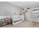 Adorable Bedroom with a white crib, rocking chair, animal-themed decor, and natural light at 541 Jerry Ln, Haines City, FL 33844