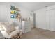 Charming Bedroom with a cozy rocking chair, dresser, and shelving for books and toys at 541 Jerry Ln, Haines City, FL 33844