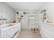 Bright Bedroom with a white crib, rocking chair, animal-themed decor, and plenty of space at 541 Jerry Ln, Haines City, FL 33844