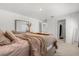 Inviting bedroom with a plush bed, ample natural light, carpeted floors, and a ensuite bathroom at 541 Jerry Ln, Haines City, FL 33844