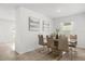 Elegant dining area featuring a stylish table with seating for six, soft lighting, and charming wall decor at 541 Jerry Ln, Haines City, FL 33844