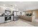 Modern kitchen open to the living area, featuring stainless steel appliances, stylish cabinetry, and plenty of counter space at 541 Jerry Ln, Haines City, FL 33844