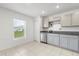 Well-lit kitchen features stainless steel appliances, granite counters, tile floors, and a large window at 541 Jerry Ln, Haines City, FL 33844
