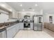 Functional kitchen with stainless steel appliances, granite countertops, and a seamless transition to the living area at 541 Jerry Ln, Haines City, FL 33844