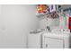 Bright laundry room featuring a modern washer and dryer, and shelving for storage at 541 Jerry Ln, Haines City, FL 33844