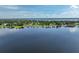 Aerial view capturing waterfront homes with docks, set against a backdrop of calm lake waters and clear skies at 6100 Alligator Lake W Shr, St Cloud, FL 34771
