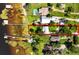Aerial view highlighting property lines with lake access, lush greenery, and a sparkling pool at 6100 Alligator Lake W Shr, St Cloud, FL 34771