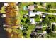 Aerial view featuring a large waterfront property with lush greenery, pool, and private docks at 6100 Alligator Lake W Shr, St Cloud, FL 34771