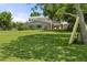 Expansive backyard featuring lush green grass, a two-story home, and mature trees providing ample shade at 6100 Alligator Lake W Shr, St Cloud, FL 34771