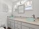 Bathroom with dual vessel sinks, granite countertop, decorative lighting and two windows at 6100 Alligator Lake W Shr, St Cloud, FL 34771