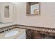Close up of a powder room, featuring granite vanity, decorative tile and mosaic mirror at 6100 Alligator Lake W Shr, St Cloud, FL 34771
