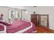 Bedroom featuring hardwood floors, natural light from the window, and ample storage space at 6100 Alligator Lake W Shr, St Cloud, FL 34771