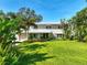 Beautiful two-story home with a well-manicured lawn, lush tropical landscaping, and an attached garage at 6100 Alligator Lake W Shr, St Cloud, FL 34771
