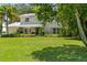 Two-story home surrounded by lush landscaping and a well-manicured lawn creating a picturesque curb appeal at 6100 Alligator Lake W Shr, St Cloud, FL 34771