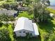 Aerial view of home, highlighting the well-maintained metal roof and lush surrounding greenery at 6100 Alligator Lake W Shr, St Cloud, FL 34771