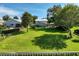 Spacious front yard with mature trees, complemented by a charming two-story home at 6100 Alligator Lake W Shr, St Cloud, FL 34771
