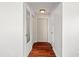 Hallway featuring hardwood floors, white walls, and access to multiple rooms at 6100 Alligator Lake W Shr, St Cloud, FL 34771