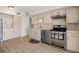 Charming kitchen featuring white cabinetry, stainless steel appliances and updated wood flooring at 6100 Alligator Lake W Shr, St Cloud, FL 34771