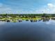 Picturesque lake view with docks extending into the water, showcasing waterfront living and recreational opportunities at 6100 Alligator Lake W Shr, St Cloud, FL 34771