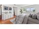 Staged main bedroom featuring hardwood floors, a large window with a view, and light colored walls at 6100 Alligator Lake W Shr, St Cloud, FL 34771