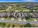 An aerial view shows a well-manicured neighborhood with lush landscaping and a beautiful pond at 688 Cordoba Dr, Davenport, FL 33837