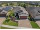 Aerial view of a home with solar panels, a screened-in lanai, and a manicured lawn at 688 Cordoba Dr, Davenport, FL 33837