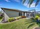 Landscaped backyard showcasing the side of the house with a screened-in patio, providing a serene outdoor living space at 688 Cordoba Dr, Davenport, FL 33837