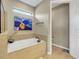 Bright bathroom featuring a soaking tub and window for natural light at 688 Cordoba Dr, Davenport, FL 33837