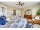 Cozy bedroom featuring a decorative bedspread, dresser with mirror, and accent chair at 688 Cordoba Dr, Davenport, FL 33837