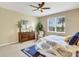 Relaxing bedroom with ceiling fan, natural light, and comfortable furnishings at 688 Cordoba Dr, Davenport, FL 33837
