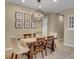 Charming dining area with wood table, chandelier, and neutral decor for elegant meals at 688 Cordoba Dr, Davenport, FL 33837
