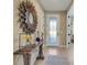 Inviting entryway featuring a decorative mirror, console table, and stylish tile flooring at 688 Cordoba Dr, Davenport, FL 33837