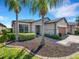 Charming home featuring manicured landscaping, stone accents, and a brick driveway at 688 Cordoba Dr, Davenport, FL 33837