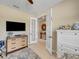 Bright home office with neutral walls, modern furnishings, and elegant French doors leading to another room at 688 Cordoba Dr, Davenport, FL 33837