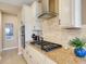 Gourmet kitchen features stainless steel appliances, granite countertops, and a modern gas range at 688 Cordoba Dr, Davenport, FL 33837