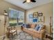 Cozy living room with a comfortable sofa, area rug, and natural light from the window at 688 Cordoba Dr, Davenport, FL 33837