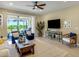 Bright living room with ample natural light, contemporary furnishings, and sliding door access to an outdoor patio at 688 Cordoba Dr, Davenport, FL 33837