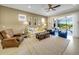 Inviting living room with neutral tones, comfortable seating, and seamless access to outdoor living spaces at 688 Cordoba Dr, Davenport, FL 33837