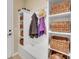 Organized mud room featuring built-in storage with baskets, coat hooks, and a convenient bench for seating at 688 Cordoba Dr, Davenport, FL 33837