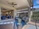 Covered outdoor patio with ceiling fan and comfortable seating area, perfect for relaxing and entertaining with a view of the living area at 688 Cordoba Dr, Davenport, FL 33837