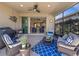 Cozy screened patio with comfortable seating, a ceiling fan, and an outdoor grill for entertaining at 688 Cordoba Dr, Davenport, FL 33837