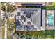 Aerial view of house featuring its roof with solar panels, a pool, and lush landscaping at 8401 Secret Key Cv, Kissimmee, FL 34747