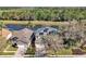 Beautiful aerial view of the home showcasing its solar panels, landscaping, and tranquil water views at 8401 Secret Key Cv, Kissimmee, FL 34747