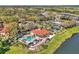 Stunning aerial view of the community clubhouse and pool, all surrounded by lush landscaping and serene lake views at 8401 Secret Key Cv, Kissimmee, FL 34747