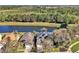 Gorgeous aerial view of home featuring a lake, solar panels, and well-maintained landscaping at 8401 Secret Key Cv, Kissimmee, FL 34747