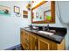 Charming bathroom featuring a double vanity, a decorative mirror, and nautical-themed accents, creating a relaxing space at 8401 Secret Key Cv, Kissimmee, FL 34747