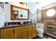 Charming bathroom featuring a double vanity, a glass shower, and nautical-themed accents, creating a relaxing space at 8401 Secret Key Cv, Kissimmee, FL 34747