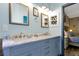 Bathroom with a marble-top double vanity, mirrors, and modern fixtures blends form and function at 8401 Secret Key Cv, Kissimmee, FL 34747